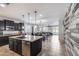 Open-concept kitchen with a large island, stainless steel appliances, and granite countertops at 7634 W Redbird Rd, Peoria, AZ 85383