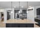 Large kitchen island with granite countertops and pendant lighting, complemented by stainless steel appliances at 7634 W Redbird Rd, Peoria, AZ 85383