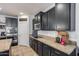 Stylish kitchen with granite countertops, black cabinets, stainless steel appliances, and modern subway tile backsplash at 7634 W Redbird Rd, Peoria, AZ 85383