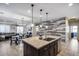 Beautiful kitchen island features granite countertops, stainless steel appliances, and a trendy decorative wood backsplash at 7634 W Redbird Rd, Peoria, AZ 85383