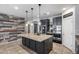 Spacious kitchen with a large island, granite countertops, stainless steel appliances, and black cabinets at 7634 W Redbird Rd, Peoria, AZ 85383