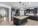 Spacious kitchen featuring black cabinets, granite countertops and stainless steel appliances at 7634 W Redbird Rd, Peoria, AZ 85383