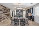 Open concept dining and kitchen area features a modern kitchen island and stylish rustic dining table at 7634 W Redbird Rd, Peoria, AZ 85383
