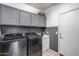 Laundry room featuring gray cabinets and a washer and dryer at 7634 W Redbird Rd, Peoria, AZ 85383