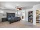 Spacious main bedroom boasts carpeted floor, adjacent bathroom and decorative shelving at 7634 W Redbird Rd, Peoria, AZ 85383