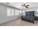Main bedroom with shuttered windows, ceiling fan and king size bed with cozy blue bedding at 7634 W Redbird Rd, Peoria, AZ 85383