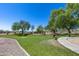 Community park with manicured lawns, walking paths, and mature shade trees at 7634 W Redbird Rd, Peoria, AZ 85383