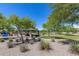 Community park featuring a shaded picnic area, playground, and grassy open spaces at 7634 W Redbird Rd, Peoria, AZ 85383