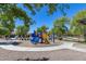 Community playground with blue slides and yellow stairs surrounded by benches and lush trees at 7634 W Redbird Rd, Peoria, AZ 85383