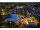 Desert home aerial showcasing luxurious outdoor living, pool, spa, and lush landscaping, with neighborhood views at twilight at 8675 S College Ln, Tempe, AZ 85284