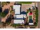 An aerial view shows the house with a white roof, pool, landscaping, and a red gazebo at 8675 S College Ln, Tempe, AZ 85284