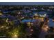 Aerial view of residential neighborhood and a home with a pool area at twilight at 8675 S College Ln, Tempe, AZ 85284