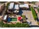 Aerial view of a luxury property with a backyard pool, shaded patio, and spacious driveway at 8675 S College Ln, Tempe, AZ 85284