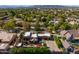 Expansive aerial view of the beautiful home showcasing a large swimming pool and surrounding lush landscape at 8675 S College Ln, Tempe, AZ 85284