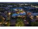 Aerial view of a well-lit property at dusk with landscaped grounds and neighboring homes at 8675 S College Ln, Tempe, AZ 85284