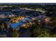 An aerial view of a house at night shows the pool and surrounding neighborhood at 8675 S College Ln, Tempe, AZ 85284