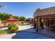 Exterior of home shows covered outdoor space, built-in fireplace and outdoor space overlooking the pool at 8675 S College Ln, Tempe, AZ 85284