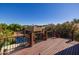 Wooden balcony overlooks a backyard featuring a pool, patio, and mature landscaping at 8675 S College Ln, Tempe, AZ 85284