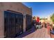 Balcony area includes wrought iron security doors, outdoor seating, and a red umbrella at 8675 S College Ln, Tempe, AZ 85284