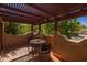Balcony with pergola features outdoor seating and views of the surrounding greenery at 8675 S College Ln, Tempe, AZ 85284