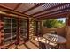 Covered patio with pergola, table, chairs, and French doors leading to the interior at 8675 S College Ln, Tempe, AZ 85284