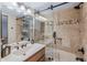 Updated bathroom featuring decorative stone tile, a sleek glass shower door, and modern fixtures at 8675 S College Ln, Tempe, AZ 85284