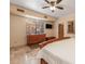 Well-lit bedroom with travertine floors, dresser, large windows, and ceiling fan at 8675 S College Ln, Tempe, AZ 85284