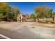 Charming gated community entrance with Tudor-style guard house and brick signage in a landscaped setting at 8675 S College Ln, Tempe, AZ 85284