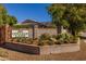 Beautiful community entrance signage with brick wall and landscaping with a partial home view at 8675 S College Ln, Tempe, AZ 85284