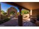 Inviting courtyard with fountain, custom gate, mature trees, and covered seating area at 8675 S College Ln, Tempe, AZ 85284