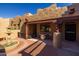 Charming courtyard featuring a fountain, covered patio with elegant seating, and lush landscaping at 8675 S College Ln, Tempe, AZ 85284