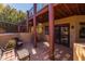 Inviting covered patio with comfortable seating, view of balcony, and access to beautifully landscaped backyard at 8675 S College Ln, Tempe, AZ 85284