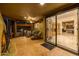 Spacious covered patio with tile flooring, lounge furniture, and a direct view of interior living space at 8675 S College Ln, Tempe, AZ 85284