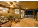 Covered patio features tile flooring, comfortable seating, and seamless indoor-outdoor living at 8675 S College Ln, Tempe, AZ 85284