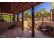Relaxing covered patio area featuring sturdy support beams, comfortable seating, and verdant outdoor views at 8675 S College Ln, Tempe, AZ 85284