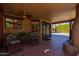 Relaxing covered patio with comfortable seating, a ceiling fan, and views of the landscaped backyard at 8675 S College Ln, Tempe, AZ 85284