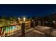 Relax on this wood deck with an amazing nighttime view of the pool and patio at 8675 S College Ln, Tempe, AZ 85284