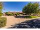 Lovely home nestled in a picturesque setting, complete with mature trees, lush greenery, and a circular driveway at 8675 S College Ln, Tempe, AZ 85284