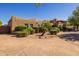 Inviting home featuring beautiful landscaping, a circular driveway, and unique architectural design, creating a welcoming atmosphere at 8675 S College Ln, Tempe, AZ 85284