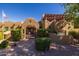Inviting home showcasing Southwestern architecture with a gated entrance, mature greenery, and unique architectural features at 8675 S College Ln, Tempe, AZ 85284