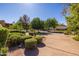 Beautiful home with well-maintained landscaping, mature trees, and a spacious driveway, creating an inviting atmosphere at 8675 S College Ln, Tempe, AZ 85284