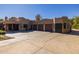 Exterior home view with garage doors and driveway, with landscaping, a desert design, and a covered patio at 8675 S College Ln, Tempe, AZ 85284