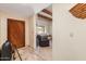 Foyer and sitting area with a beam ceiling accent, tile floor, dark wood door, and a large recliner at 8675 S College Ln, Tempe, AZ 85284