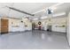 A large three car garage with epoxy floors, storage cabinets and work area at 8675 S College Ln, Tempe, AZ 85284