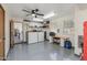 A spacious garage features an epoxy floor, lots of storage, work space, and good lighting at 8675 S College Ln, Tempe, AZ 85284