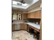 Bright kitchen featuring a skylight, tiled floor, and breakfast bar with seating at 8675 S College Ln, Tempe, AZ 85284
