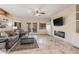 Spacious living room with modern fireplace, large windows, and comfortable seating at 8675 S College Ln, Tempe, AZ 85284