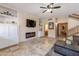 Cozy living room with modern fireplace, TV, built-in shelving, and tiled floors at 8675 S College Ln, Tempe, AZ 85284