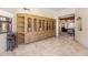 Open-concept living space with built-in shelving, a wine rack, and tiled floors at 8675 S College Ln, Tempe, AZ 85284