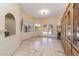 Large living space with travertine flooring, built-in cabinetry, and French doors at 8675 S College Ln, Tempe, AZ 85284